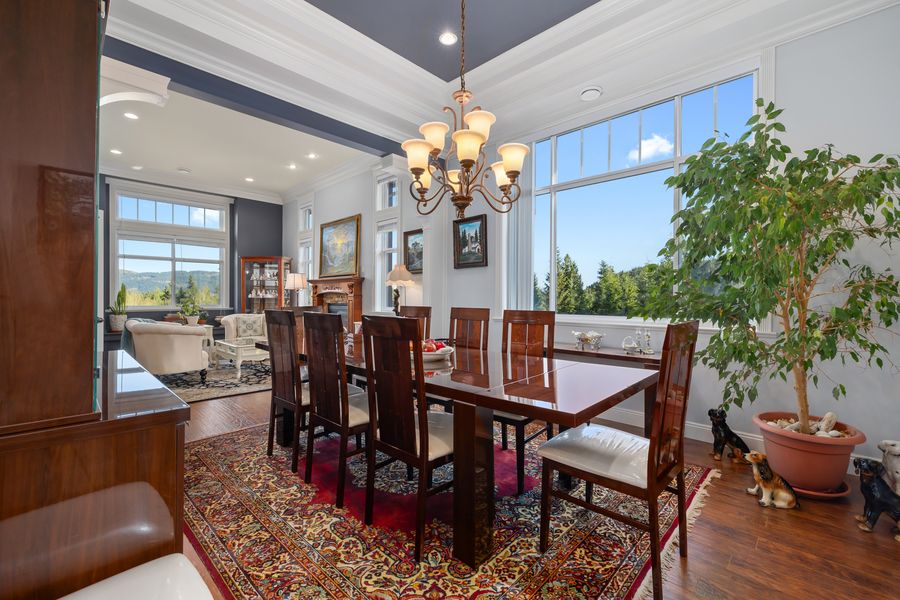 Formal dining room with forest and mountain views